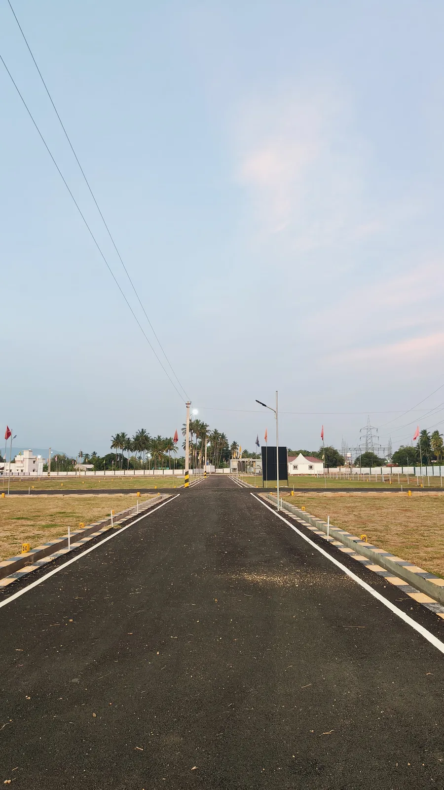 Open, airy Valapadi plot layout at dusk, Salem district